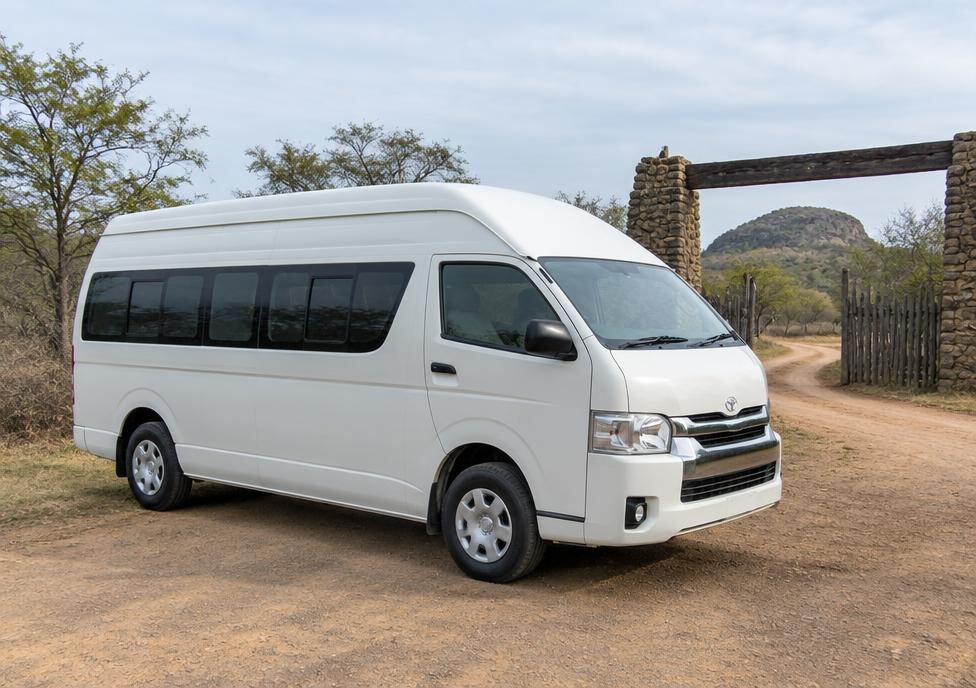 White high roof van near a safari park entrance in Sri Lanka